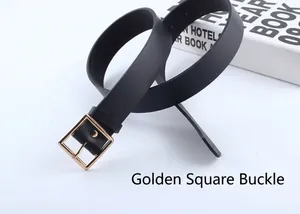 Detail view of a black leather belt with a polished gold square buckle on books