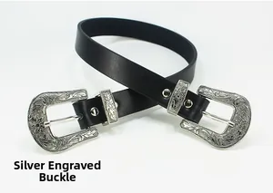 Close-up of vintage engraved silver double buckles on a black leather belt for women