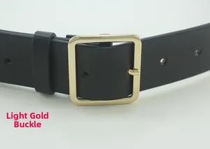 Detail of black leather belt featuring a polished light gold square buckle and fine texture