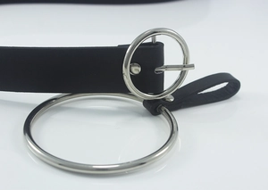 Detail shot of black leather belt featuring double silver metal rings in punk style