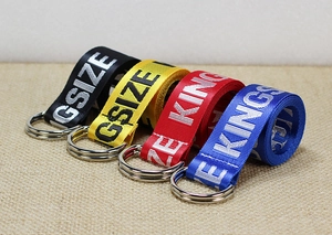 Detail showing colorful nylon belts with double D-ring buckles and jacquard lettering