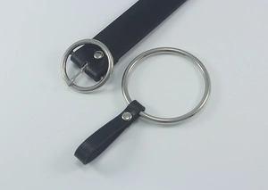 Close-up of black leather belt featuring double silver O-ring buckles and matte texture