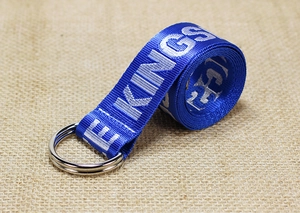 Close-up of blue nylon canvas belt with white KINGS lettering and double D-ring buckle