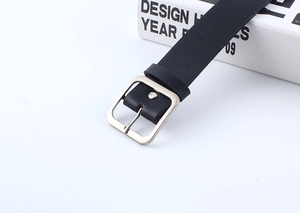 Close-up of matte black leather belt featuring a minimalist silver square metal buckle