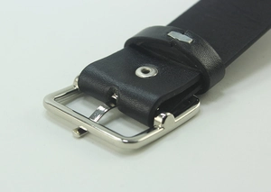 Detail of a black leather belt featuring a polished silver square pin buckle close-up