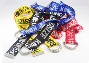 Detail of colorful nylon canvas belts featuring double D-ring buckles and letter patterns