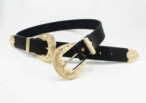Detailed view of vintage western leather belt featuring dual engraved gold buckles