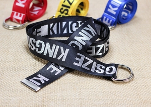 Close-up of black nylon canvas belt with white Kingsize letters and metal double D-ring buckle
