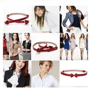 Détail d'une ceinture rouge en cuir verni pour femme avec boucle dorée en forme de papillon