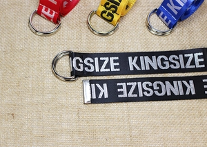 Close-up of colorful nylon canvas belts with double D-ring buckles and Kingsize print