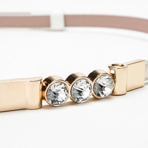 Elegant thin pink faux leather belt for women featuring a gold buckle with three rhinestones