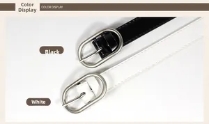 Detail view of slim black and white belts with silver oval buckles and color display text