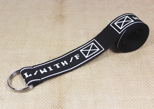 Detail of black nylon canvas belt with double D-ring metal buckle and street style letters