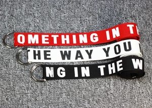 Three nylon canvas belts in red, white, and black with double D-ring silver metal buckles