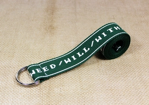 Detail of army green nylon belt with white lettering and silver double D-ring buckle