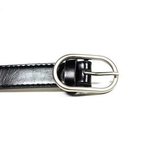 Classic black leather skinny belt for women with silver oval buckle on white background