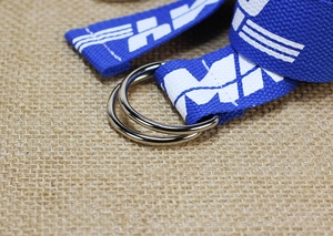 Detail of blue nylon canvas belt with double D-ring buckle and white printed lettering