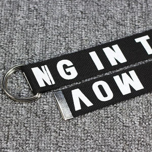 Canvas D-ring belt with white artistic lettering and metallic double buckle for casual style