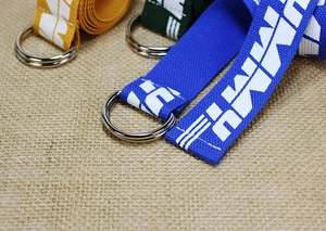 Detail of colorful nylon belts with silver double D-ring buckles and letter patterns
