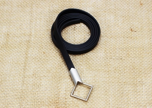Detail of slim black leather belt featuring a silver square hollow metal buckle