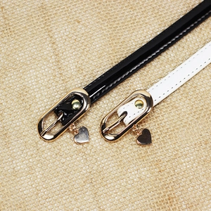 Chic patent leather skinny belts in black and white with gold heart charm buckle