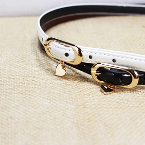 Slim patent leather belt for women in black and white with golden heart pendant buckle