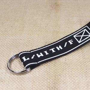 Black nylon canvas belt with silver double D-ring buckle and white graphic letter pattern