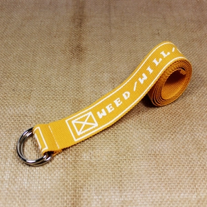 Yellow nylon canvas belt with double silver D-rings and white lettering on rustic fabric