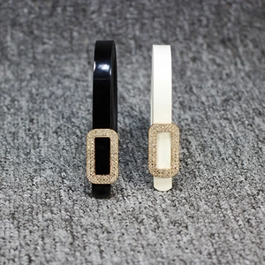 Set of slim black and white patent leather belts with sparkling rhinestone square buckles
