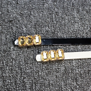 Bow knot patent leather skinny belt with amber stones in black and off-white colors