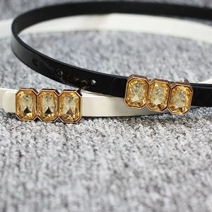 Slim patent leather bow belts in black and white with gold crystal buckles for dresses