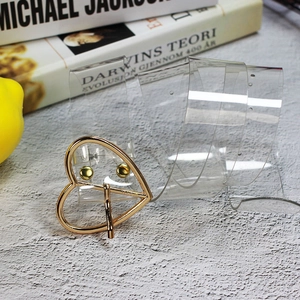 Dettaglio della cintura in PVC trasparente con fibbia in metallo dorato a forma di cuore