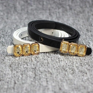 Women's slim patent leather bow belt in black and white with crystal buckles