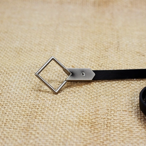 Minimalist black leather skinny belt for women with a silver geometric square metal buckle