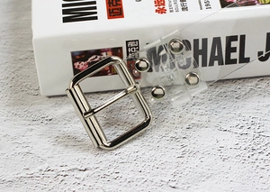 Macro detail of transparent PVC belt with silver metal buckle and reinforced rivets