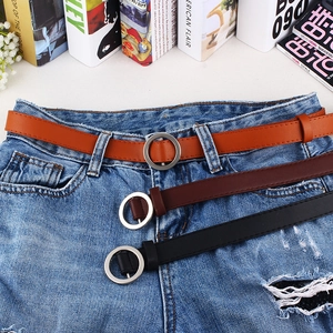 Three minimalist faux leather skinny belts with silver round buckles in brown and black