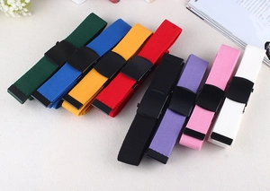 Detail view of colorful nylon canvas belts with matte black buckles in eight vibrant colors