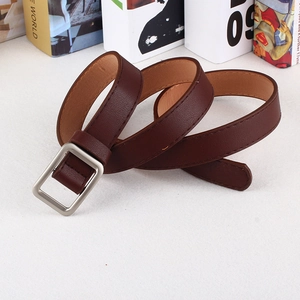 Detail of slim dark brown lychee texture leather belt with a brushed silver square buckle
