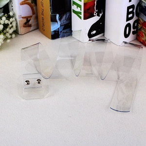 Transparent plastic cake collar roll with elegant metal buckle on white background