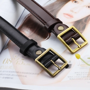 Close-up of vintage square needle buckles on black and brown leather belts for jeans