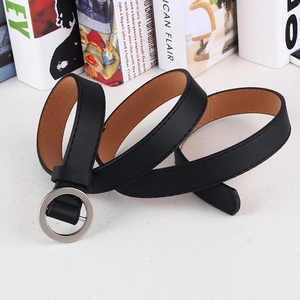 Detailed close-up of a black faux leather belt featuring a silver round buckle and stitching