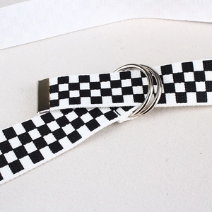 Close-up of checkerboard nylon canvas belt featuring durable silver double D-ring buckles