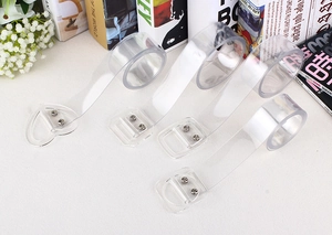 Detailed view of four transparent PVC belts with heart, D-ring, and square buckles