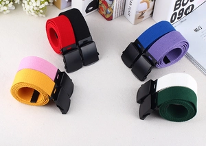 Detailed view of eight colorful nylon canvas belts with matte black automatic buckles