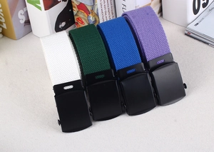 Close-up of multicolored nylon canvas belts with matte black buckles and woven texture
