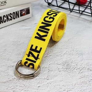 Detail of yellow industrial canvas belt with double D-ring buckle and black typography
