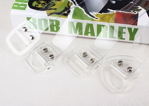 Detail view of transparent PVC wide belts with silver rivets and varied buckle shapes