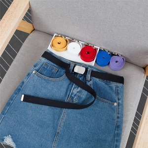 Close-up of colorful canvas belts with smooth metal buckles for casual dress decoration