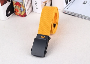 Detail of yellow nylon canvas belt with textured weave and matte black metal buckle
