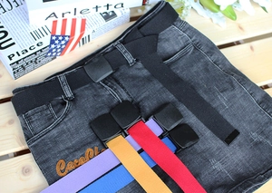 Close-up of colorful nylon canvas belts with plastic buckles on casual denim shorts